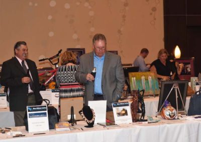 People browsing items at a charity auction event.