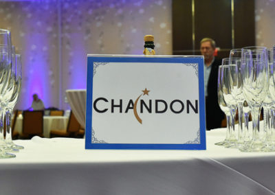 A table full of champagne glasses and a sign that says chandon.