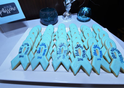 A plate of cookies with blue ribbons on it.
