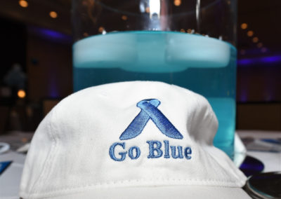 A white hat with the word go blue on it.