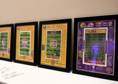 Four framed sports memorabilia posters on display, featuring lsu tigers football games from various championship matches.